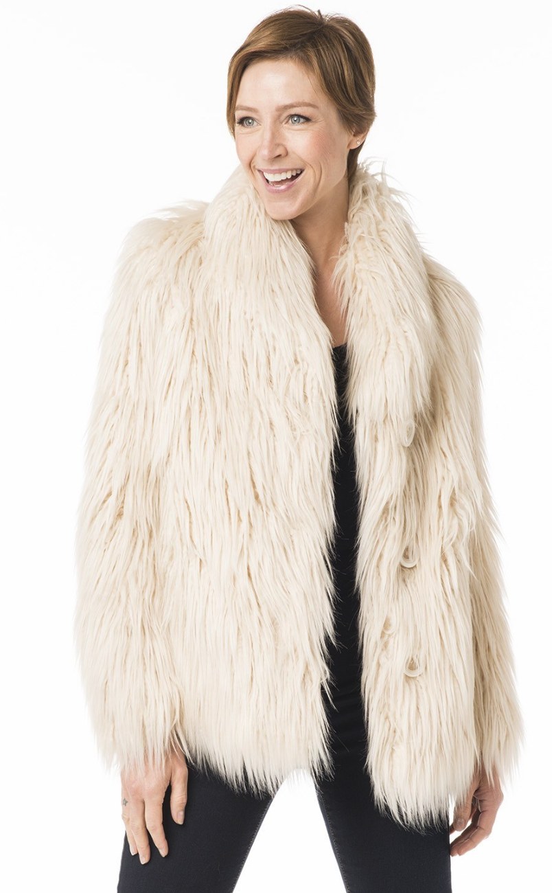 Close-up of a Nuage faux fur coat showing rich ribbed texture and polished button detail